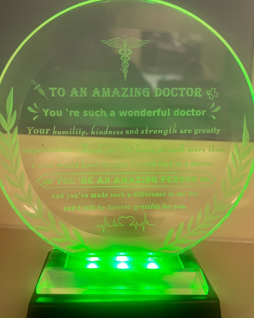 A trophy engraved with the words “To An Amazing Doctor” sits inside Ally Medical ER Bastrop after cancer survivor Chris Hill presented it to Dr. Bao Pham, thanking him for helping diagnose his stage 3 colon cancer.