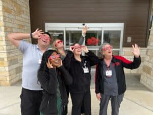 Dripping Springs staff proudly showing off their brand-new eclipse glasses!